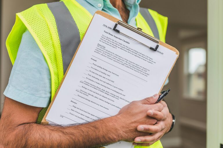Insurance adjuster with clipboard documenting water damage claim in Gilbert AZ
